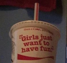 a paper cup with a straw in it that says girls just want to have fun