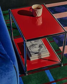 a red coffee table with a magazine on it