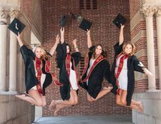 four graduates jumping in the air with their caps and gowns