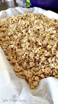 an uncooked granola pie sitting on top of a white paper covered table