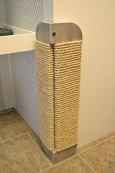 a bathroom with a basket on the floor next to it's toilet paper dispenser