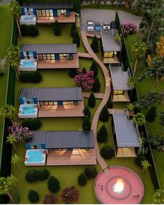 an aerial view of a house with hot tubs in the yard and landscaping around it