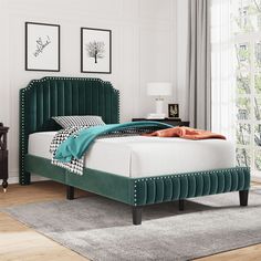 a bed with green velvet headboard and foot board