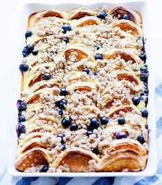 a casserole dish with blueberries and crumbled toppings on top