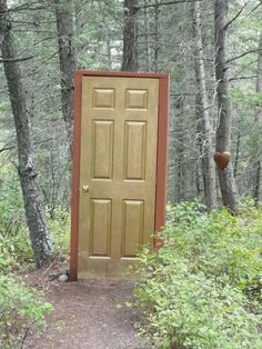 an open door in the middle of a forest