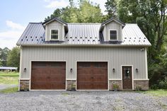 two garages are shown in the middle of a gravel lot with trees around them