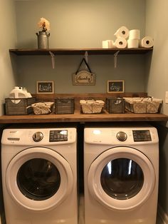 a washer and dryer in a room with shelves on the wall above them