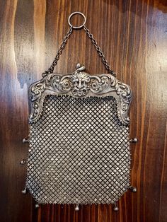 This magnificent crisscross pattern Chatelaine purse is perfect for your formal event or anytime you want to feel fancy! Featuring a Gargoyle in the center, and a scroll design on either side, this unique work of art was made by Gorham Mfg. Co. in 1901. For easy tarnish preventative storage, add https://www.etsy.com/listing/779223480. We recommend using our four piece cleaning kit to maintain a beautiful shine: https://etsy.me/3ordGDm. Details: #B 820 M Sterling, year mark 1901, 4 1/2 in. wide x 1920s Great Gatsby, Mesh Crochet, Purse Collection, Mesh Bags, French Art Nouveau, Embroidery Beads, Silver Bags, Vintage Clutch, Vintage Wardrobe