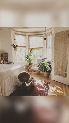 a bedroom with a bed, chair and rug in it's center area next to a window