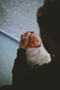 a man holding a baby in his arms