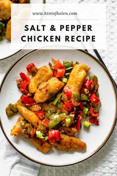 two plates filled with chicken and peppers on top of a white table cloth next to a fork