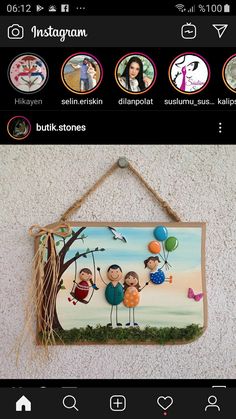 a wooden sign hanging from the side of a wall with pictures on it and balloons in the air