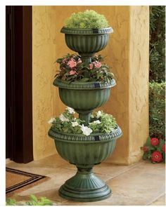 three tiered planter with flowers in it