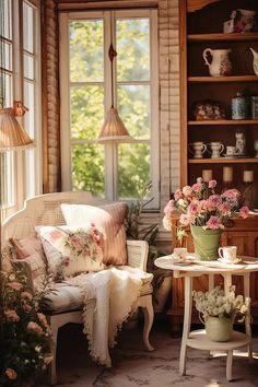 a living room filled with lots of furniture and flowers in vases on the table