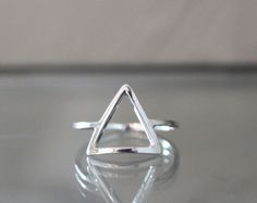 I handcraft each triangle ring out of tarnish resistant Argentium sterling silver square wire. I give it high polish for a clean modern look. It's strong and sturdy for everyday wear and care. Each ring is made to order just for you! P R O D U C T I O N ~ T I M E : Depending on my current amount of orders, it usually takes me 1-2 weeks to craft your item. Message me if you need a rush order! Send questions my way anytime! Peace & Gratitude, ♥Ali Rae Additional ~ D E T A I L S What is Argenti Geometric Silver Ring As Gift, Silver Geometric Rings As Gifts, Silver Geometric Ring As Gift, Silver Geometric Ring Gift, Silver Geometric Ring For Gift, Formal Triangle Sterling Silver Jewelry, Adjustable Geometric Rings For Gifts, Geometric Sterling Silver Ring, Adjustable Geometric Rings As Gift