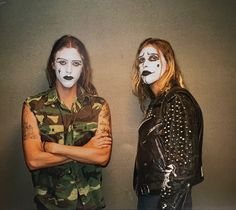 two people with painted faces standing next to each other