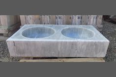 two concrete sinks sitting on top of a wooden pallet