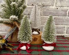 three small christmas trees sitting on top of a table