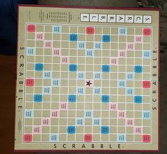 a scrabble board sitting on top of a wooden table