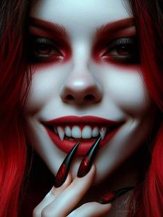 a woman with red hair and makeup is holding her hand to her mouth while wearing vampire makeup