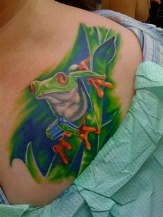 a woman with a frog tattoo on her shoulder