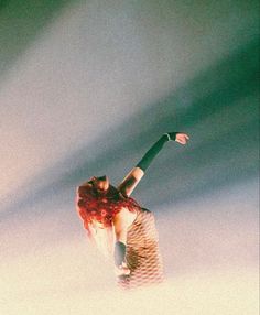 a woman with red hair is in the air