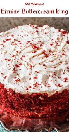 a red velvet cake with white frosting and sprinkles on a plate