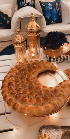 a large cake sitting on top of a table next to candles and other decor items