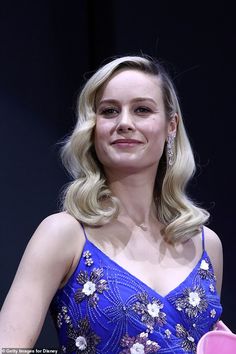 a woman with blonde hair wearing a blue dress