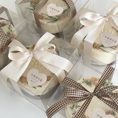 four boxes with bows and labels on them