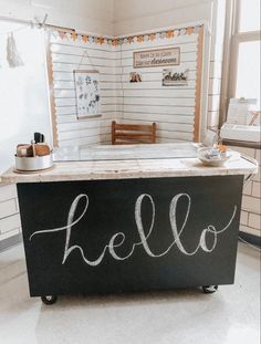 a chalkboard with the word hello written on it in front of a kitchen counter