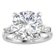 a diamond engagement ring with two side stones