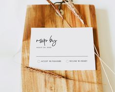 a business card sitting on top of a wooden cutting board next to some twine