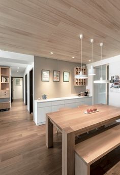 a wooden table sitting in the middle of a kitchen