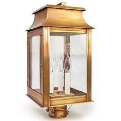 an old fashioned brass lantern with two wine glasses on the front and side glass panels