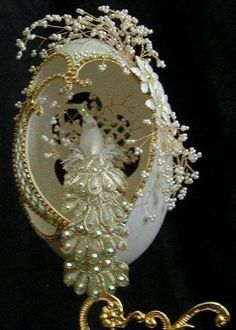 a white and gold brooch with pearls on it