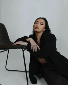 a woman sitting on a chair with her legs crossed