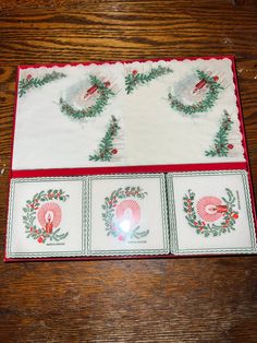 two placemats with christmas wreath designs on them