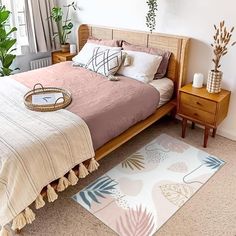 a bedroom with a bed, nightstands and potted plants on the side table