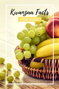 a basket filled with fruit sitting on top of a wooden table next to green grapes