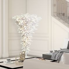 a living room filled with furniture and a tall white vase on top of a coffee table