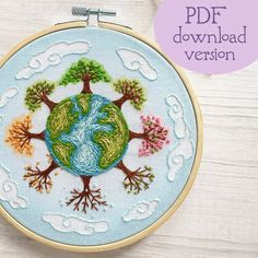 the earth is surrounded by trees and clouds in this hand embroidered hoop art project for kids