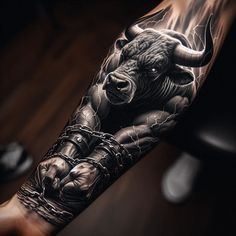 a man's arm with a bull tattoo on it