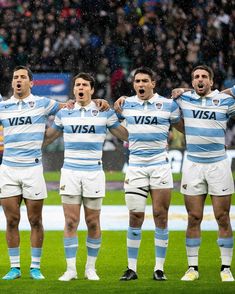 the rugby players are singing in the rain