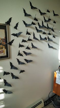 a bunch of bats are hanging on the wall