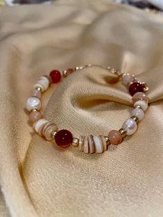 Part of the Red Sea Collection, the Red Sea Bracelet is inspired by one of the four boundaries of the Promised Land that God allotted to the Israelites, as detailed in Numbers 34:1-12. This bracelet is a beaded work consisting of carnelian, assorted agate, shells, and faux pearl beads. It has multiple chain links to clasp the bracelet together so that you can adjust the bracelet to your liking. :) Elegant Red Beaded Bracelets With Spacer Beads, Elegant Adjustable Red Rosary Bracelet, Elegant Red Hand-strung Beaded Bracelets, Elegant Handmade Red Beaded Bracelets, Bohemian Red Beaded Bracelet With Spacer Beads, Bohemian Red Beaded Bracelets With Spacer Beads, Red Beaded Pearl Bracelet With Round Beads, Red Bohemian Beaded Bracelets, Elegant Red Beaded Bracelets