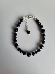 "This bracelet consists of Blue Sandstone gemstones, matching Swarovski crystal and sterling silver beads and findings. The bracelet has a 1\" extension with a beaded drop making it adjustable. These gemstones are a navy blue color with golden sparkles.  Custom Orders are always welcome! Ask about free sizing." Sterling Silver Crystal Bracelet With Round Beads, Adjustable Faceted Sterling Silver Crystal Bracelet, Adjustable Faceted Beaded Bracelets In Sterling Silver, Adjustable Faceted Sterling Silver Beaded Bracelets, Adjustable Nickel-free Crystal Bracelets, Adjustable Nickel-free Crystal Bracelet, Elegant Faceted Czech Glass Bracelets, Elegant Faceted Czech Glass Bracelet, Blue Beaded Crystal Bracelet In Sterling Silver