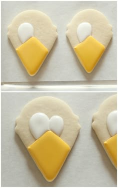 the cookies are decorated with yellow and white icing