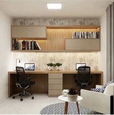 an office with two desks, chairs and bookshelves on the wall above them