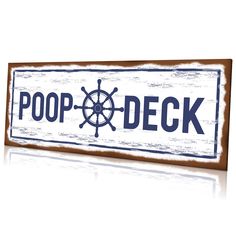 a wooden sign with the word poop - deck written in blue ink on it